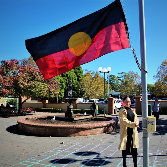 Cheree Toka raising Aboriginal flag in Summer Hill 540